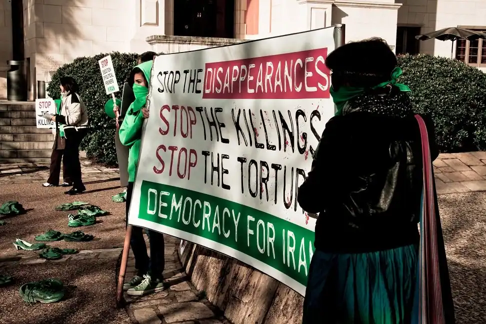 Students hold up a sign saying stop the killings, stop the disappearances