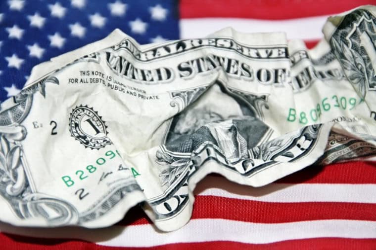 A dollar crumpled atop the Unite States flag
