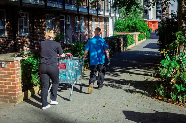 Housing association workers deliver water for tenants in the buildings (Photo: Dave Gilchrist)