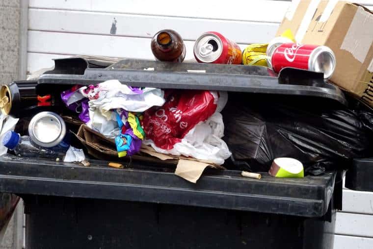 Stock image of overflowing rubbish bin